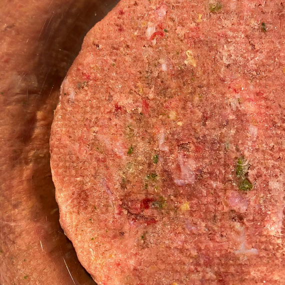 Close up view of smallbatch raw dog food patty.
