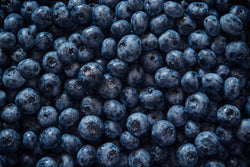 Close up view of a large pile of fresh blueberries.